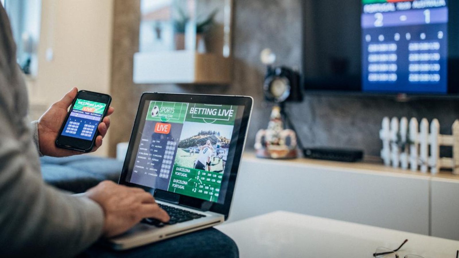 A Person Playing Online Betting on Mobile and Desktop